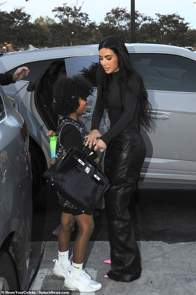 Her dinner look: During their outing, she wore a figure-hugging long-sleeved bodysuit tucked into leather biker pants