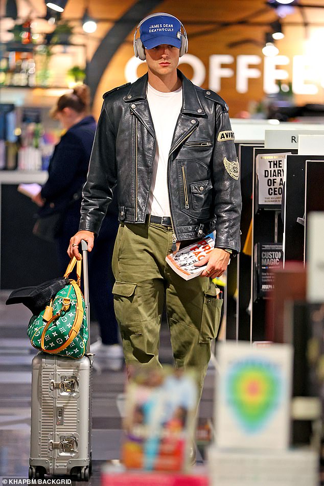 He added a plain white T-shirt and army green pants, as well as black leather boots