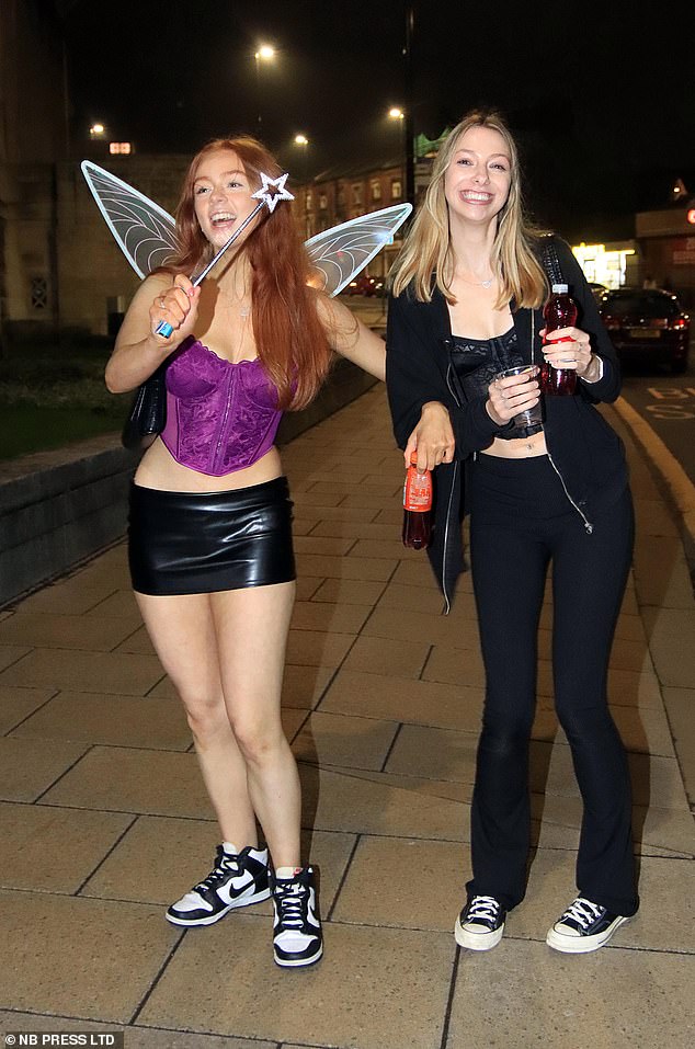 A girl dressed as a fairy is helped by her partner on her way to Leeds city centre