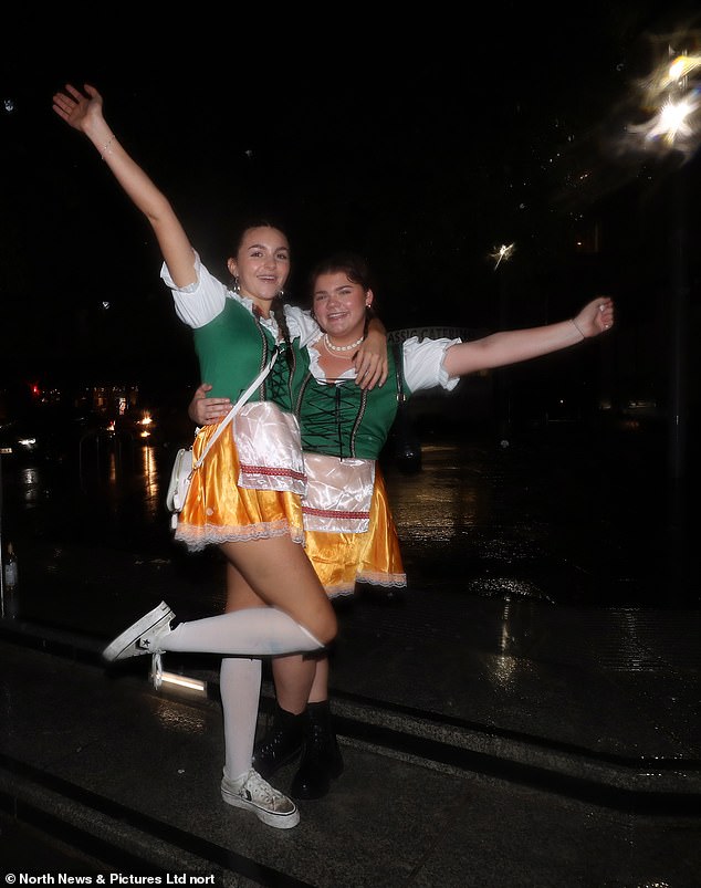 Two girls dressed as barmaids didn't let the rain deter them as they headed to Newcastle