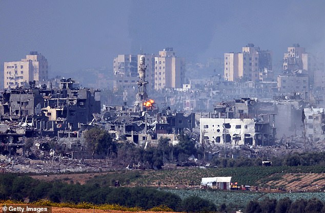 A rocket hits a minaret in Gaza on Saturday - as Israel's deadly nighttime bombardment of the enclave continued into the day