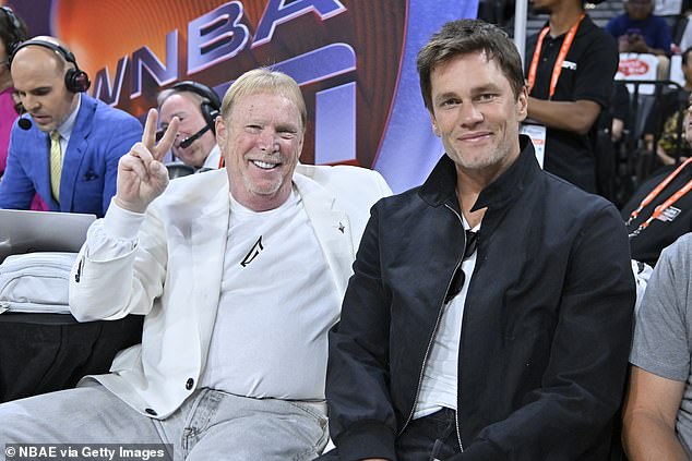 Brady, pictured with Raiders owner Mark Davis, retired in February at the age of 45