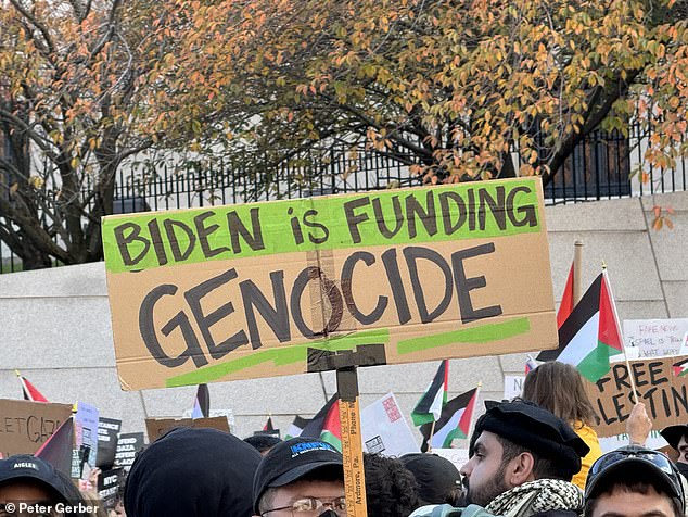 Other signs read: 'Biden is financing genocide' and 'occupation is a crime'