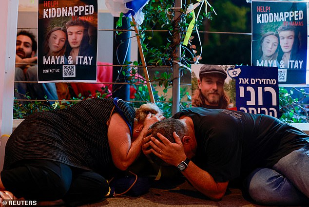 People run for cover as the sirens of incoming rockets sound, amid the ongoing conflict between Israel and the Palestinians