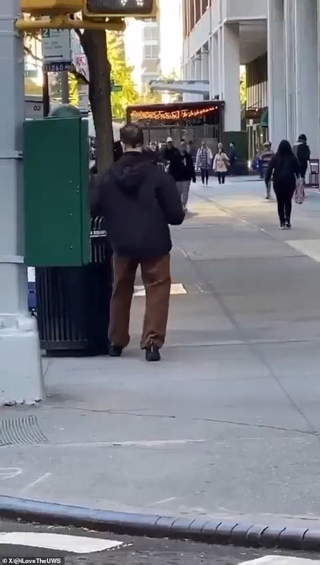 The Broadway producer walks a few steps forward and throws it into a trash can in the main Jewish quarter