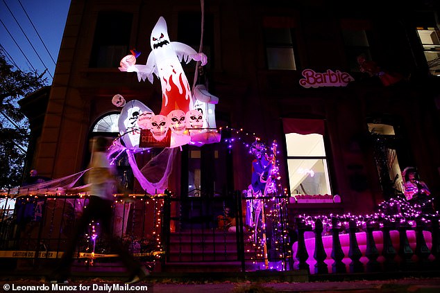 New Yorkers celebrate elaborate haunted house facades and ghostly figures adorn the sidewalks