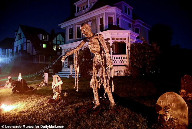 A skeletal ghost is surrounded by several gravestones, one of which solemnly bears the inscription 'RIP John'