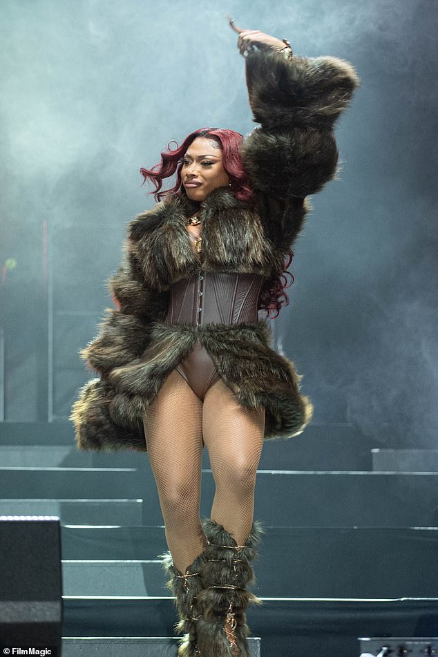 Lavish: Earlier in the day she arrived on stage in a lavish fur-trimmed coat and matching boots, before ditching the outerwear as her performance heated up