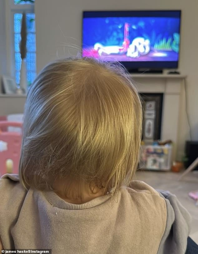 Daddy's girl: Haskell shared photos of Bodhi as she watched TV ahead of the grand final on Saturday night