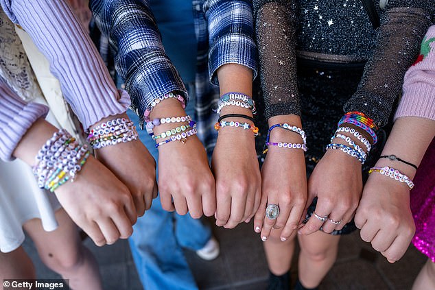 Taylor Swift fans in California show off their friendship bracelets during the opening night of 'Taylor Swift: The Eras Tour' in theaters earlier this month