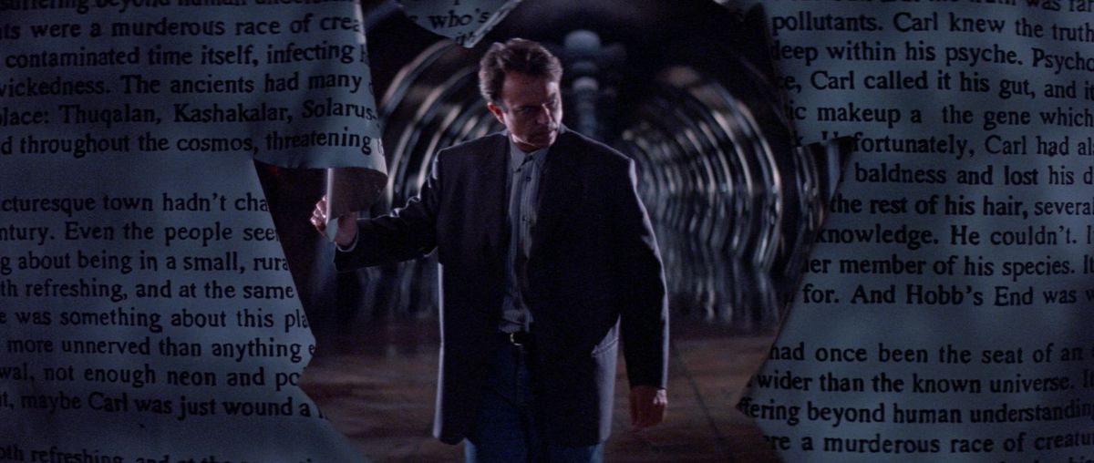 Sam Neill as John Trent through the hole as alienation on the page of text in The Madman.