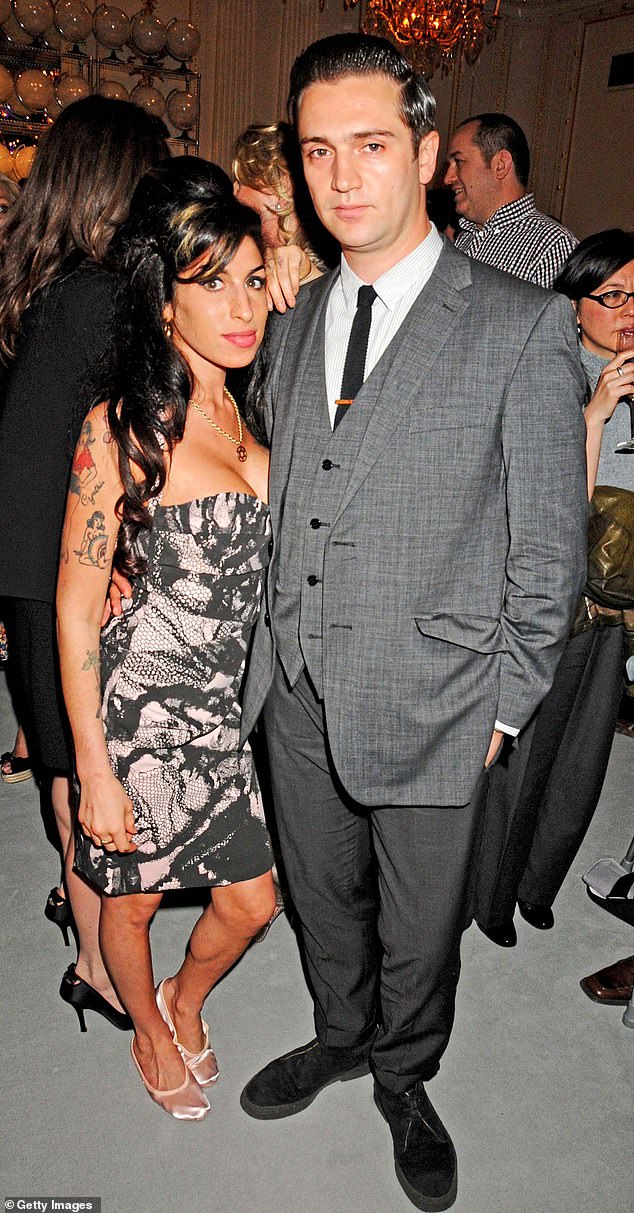 Amy quickly moved on with film director Reg Traviss (right) with whom she was still in a relationship when she died of accidental alcohol poisoning on July 23, 2011.