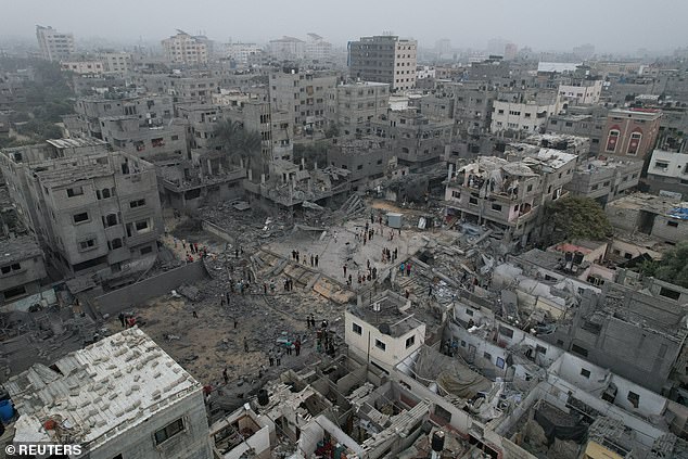 A view of the remains of a mosque and houses destroyed by Israeli attacks in the central Gaza Strip