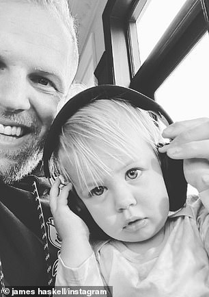 Listen in: The child wore her father's headphones as she posed for a photo