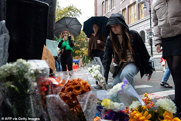 Tragic: Mourners lay floral tributes to Perry outside the New York apartment building used as an exterior shot in Friends