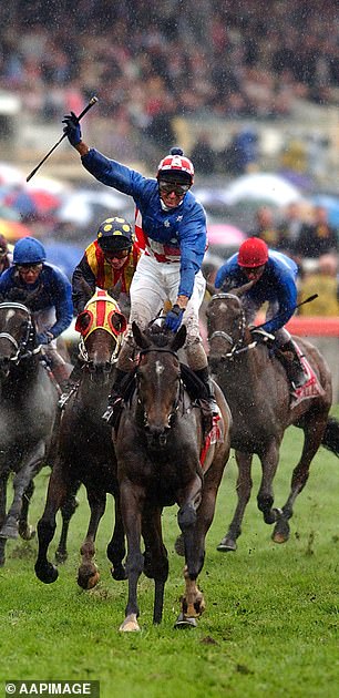 Boss raises his hand in triumph after riding Makybe Diva to win the 2004 Melbourne Cup