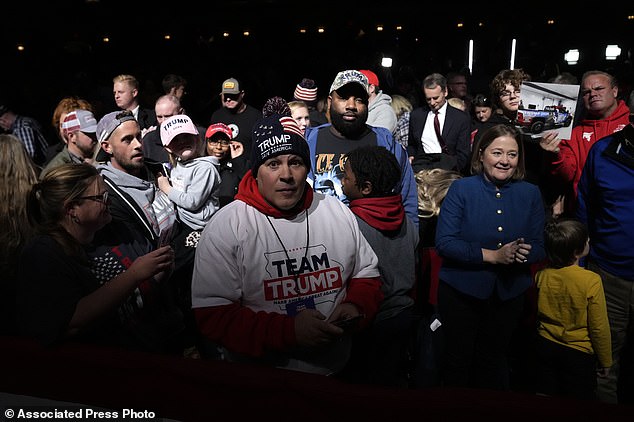 Audience members react as former President Donald Trump leaves the stage after a rally for a caucus meeting.  Donald Trump has predicted he would win the Republican presidential caucuses in Iowa in January, brushing aside his advisers' caution not to exaggerate expectations.