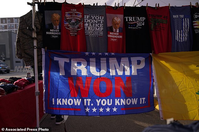 Merchandise is seen in a vendor tent outside a Trump caucus rally