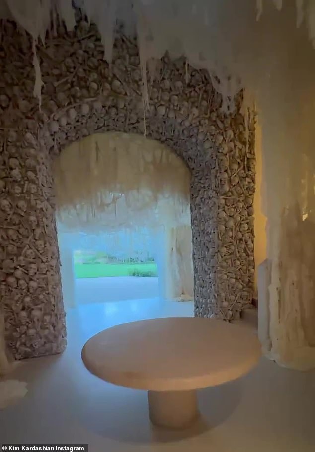 Skulls galore!  In the cream-colored hall, fabric resembling spider webs hung from various points in the ceiling, along with another arch of bones