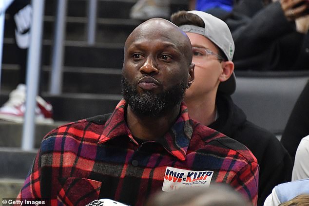 Cool: Basketball player Lamar Odom was also present and wore a checked red and black jacket