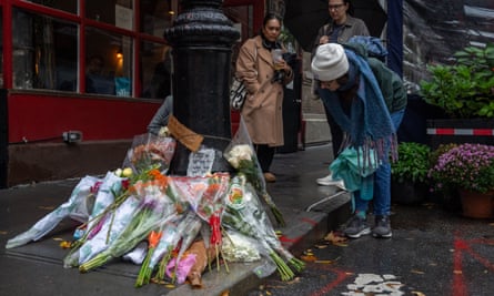 Floral tributes for Matthew Perry outside the apartment building used as an exterior shot on the TV show Friends, New York on October 29, 2023.