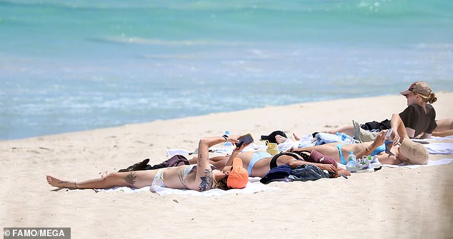 The Matildas players sunbathed on City Beach after Sunday's huge win