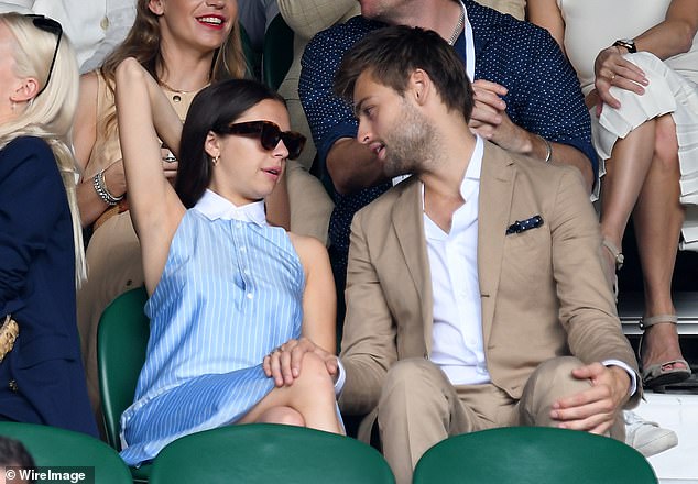 Inseparable: Douglas had his hand on Bel's knee as they watched the match together in 2017