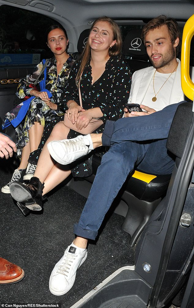 Having fun: Douglas and Bel are pictured on a night out with friends in 2018