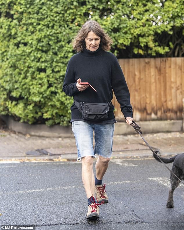 Fresh air: She looked dejected as she stepped outside for a short walk with her pet