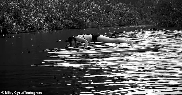 Plank position: The singer was in a plank position on the paddleboard