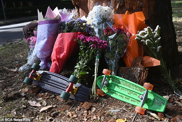 A makeshift memorial was erected at the base of the tree with many flowers and two skateboards to commemorate their partner