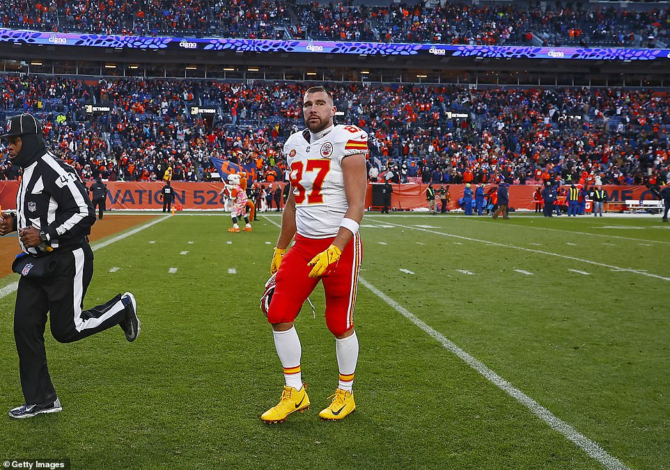 Travis Kelce walks off the field after struggling with a game his girlfriend didn't want to attend.  The Broncos leaned into the Kelce-Swift love story and trolled the tight end by blasting Swift's song Shake It Off over the stadium speakers at the end of the game