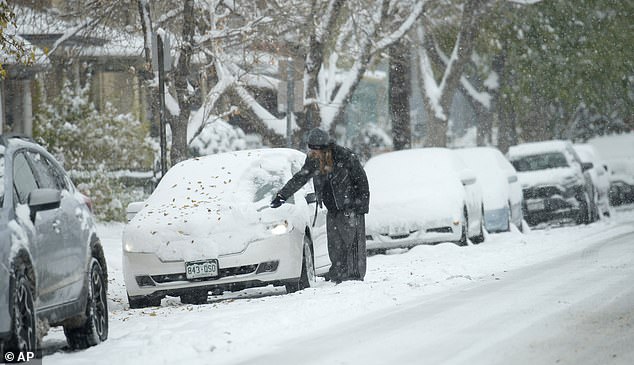 The cold air phenomenon started Monday and will peak later this week.  As the weather mass moves east, several seasonal weather records could be broken in states, meteorologists warn.  A motorist is seen clearing snow from his car in Denver on Sunday