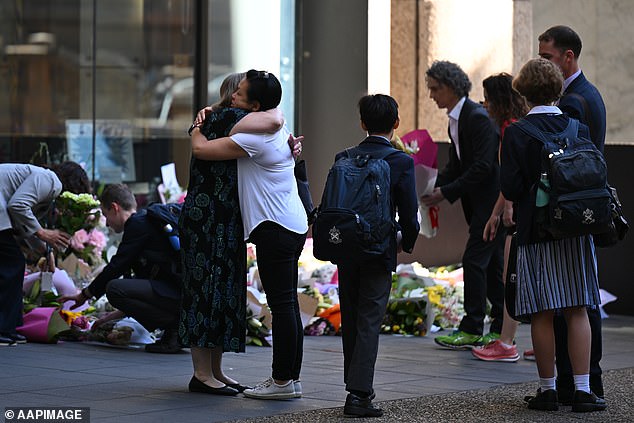 Students and staff at St Andrew's Cathedral School laid flowers and hugged each other on Monday after pupils returned to school for the first time