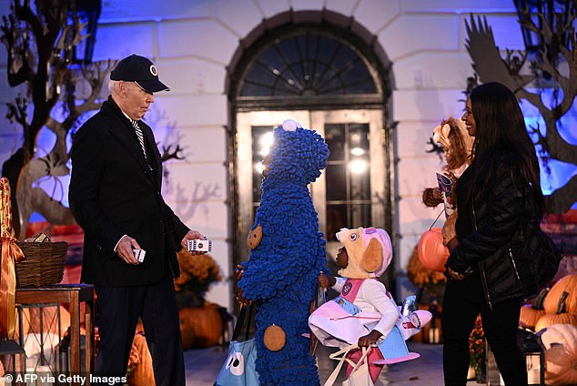 1698710166 711 No costume Joe Biden DROPS candy when he sees kids