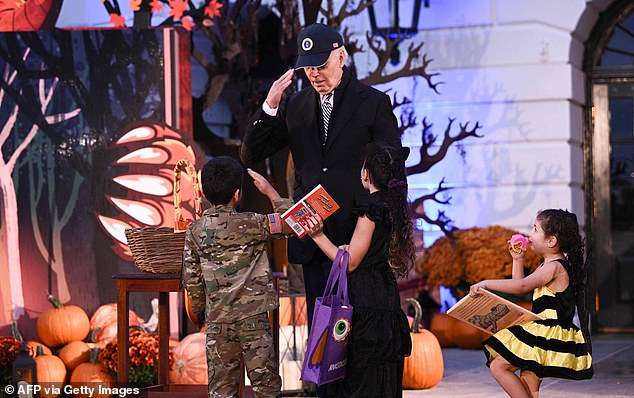 President Biden greets a boy dressed in military gear