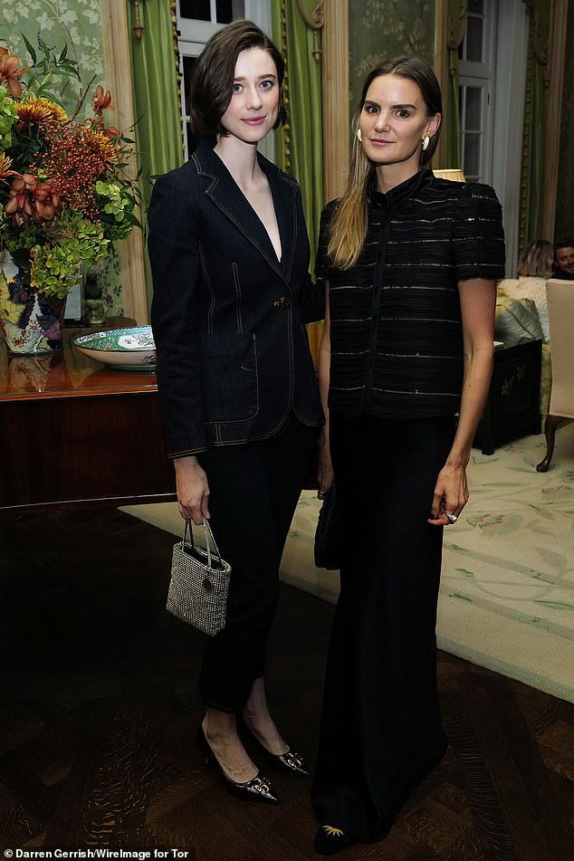 Stylish: Her sister Catherine put on a trendy display in a simple black blazer and pantsuit, adding height to her body with sparkling pumps (pictured with Charlotte Rey)