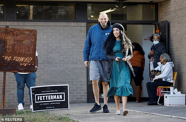 John (left) and Gisele (right) Fetterman leave their polling place in Braddock, Pennsylvania on Election Day.  The Democrat would defeat Republican Dr. later that evening.  Defeating Mehmet Oz