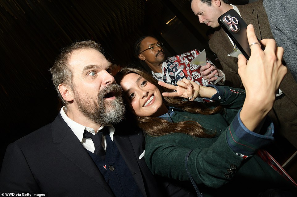 Smile!  Elsewhere at the Thom Browne party, Stranger Things star David Harbor (L) made faces as he posed for a selfie with Bupkis actress Chase Sui Wonders (R)