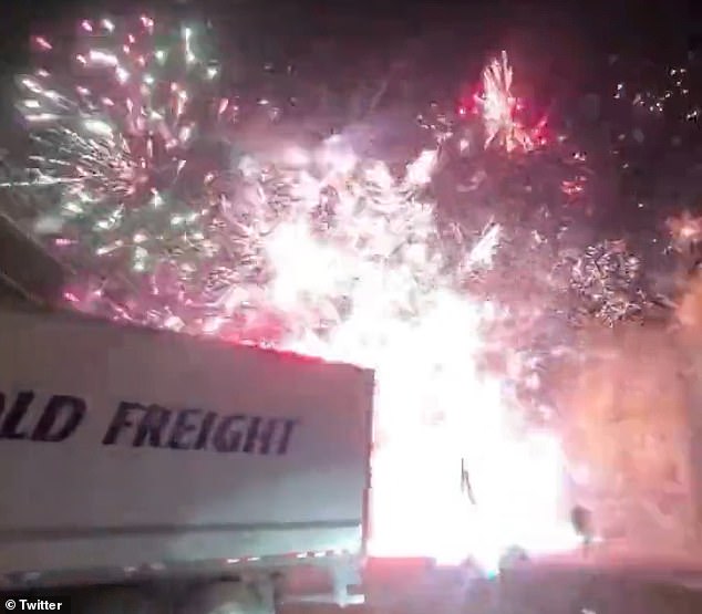 Video taken by people at the scene shows fireworks exploding high in the sky above the highway as continuous pops and bangs are heard