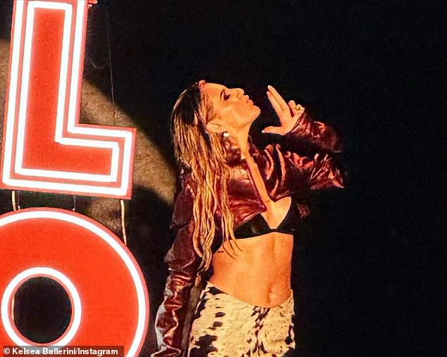 Smoking gun: She also shared a photo of herself posing next to a lit neon sign during a shoot