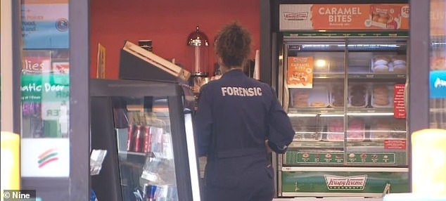 Forensic officers are seen at the petrol station after Mrs Murphy was attacked