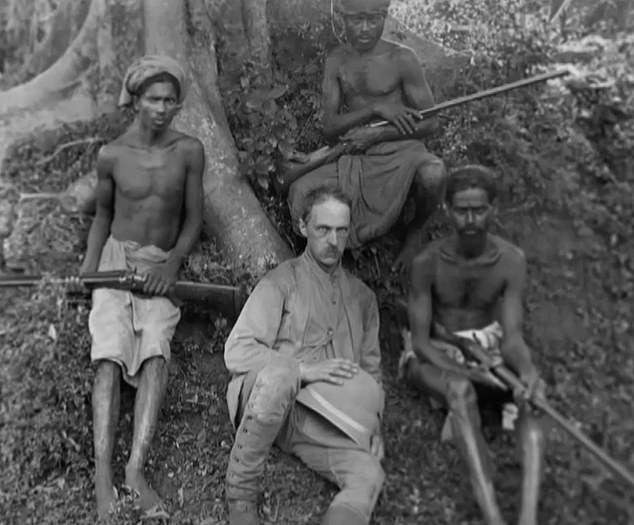 Colonel James Harrison is seen on one of his expeditions in Africa.  The explorer returned with six members of the Bambuti tribe