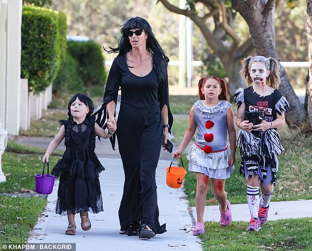 Candice walked hand in hand with her girls as they knocked on the doors of neighboring homes asking for candy