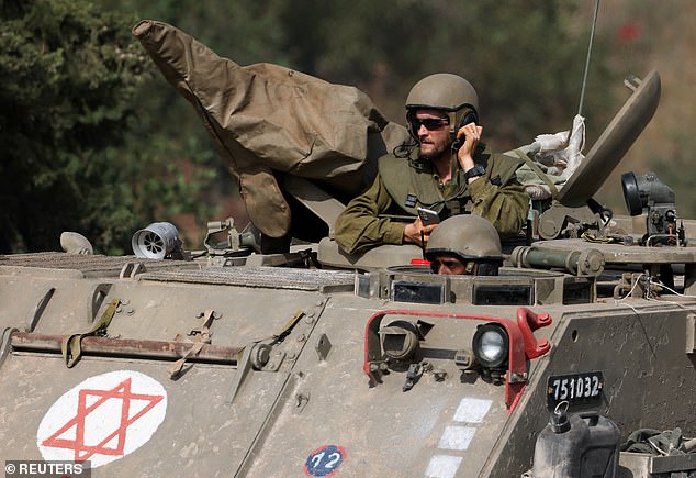 Israeli soldiers drive medical military vehicles near Israel's border with Lebanon, northern Israel, October 31, 2023