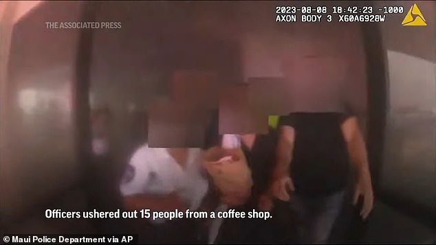 Officers led 15 people out of a coffee shop, seen here, as smoke swirled in the air around them