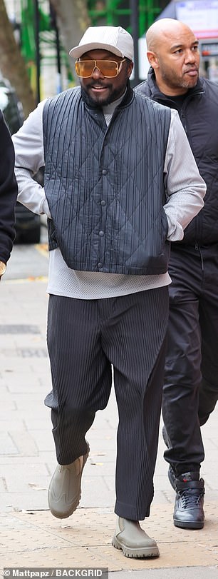 Style: Will.i.am stepped out to the This Morning studio wearing a high neck top and navy waistcoat