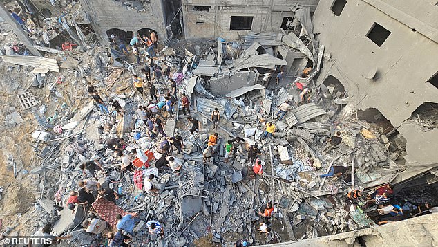 Palestinians search for victims at the site of Israeli attacks on homes in the Jabalia refugee camp in the northern Gaza Strip