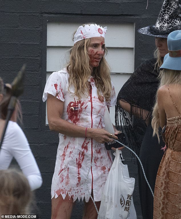 Elsa donned a white mini dress with bloody splatters, a wig and a headpiece