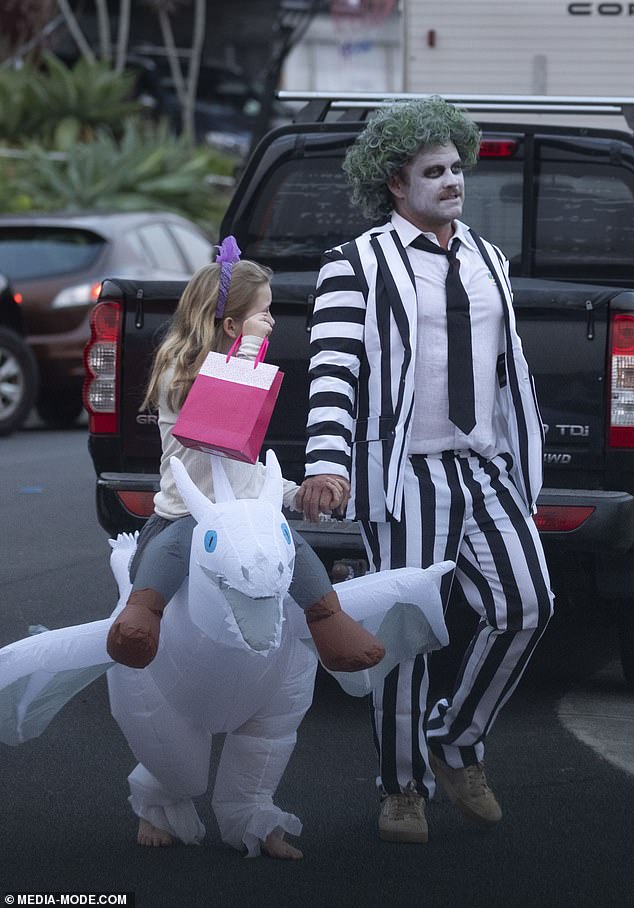 Luke held the children's hands as they collected candy